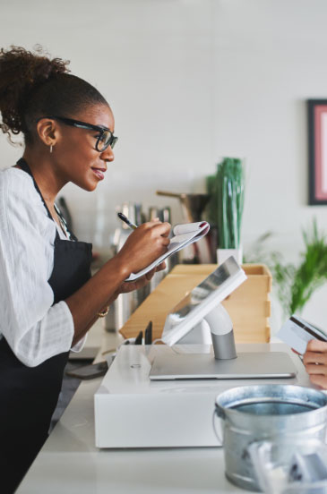 A cashier taking a customer's order at a point-of-sale system