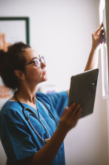 Medical professional looking at x-rays