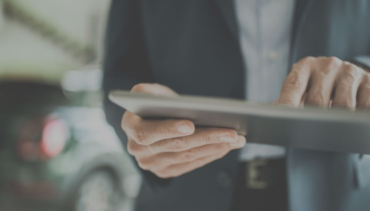 Close-up of a person's hands holding a tablet computer
